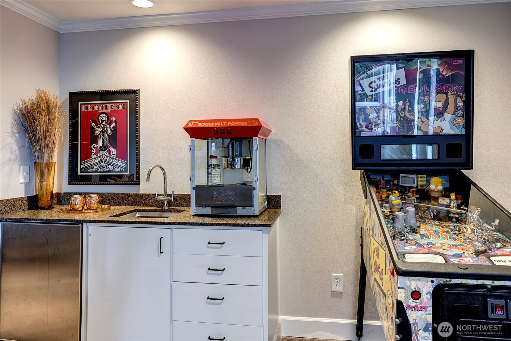 wet bar with a mini fridge keeps snacks and drinks within easy reach.