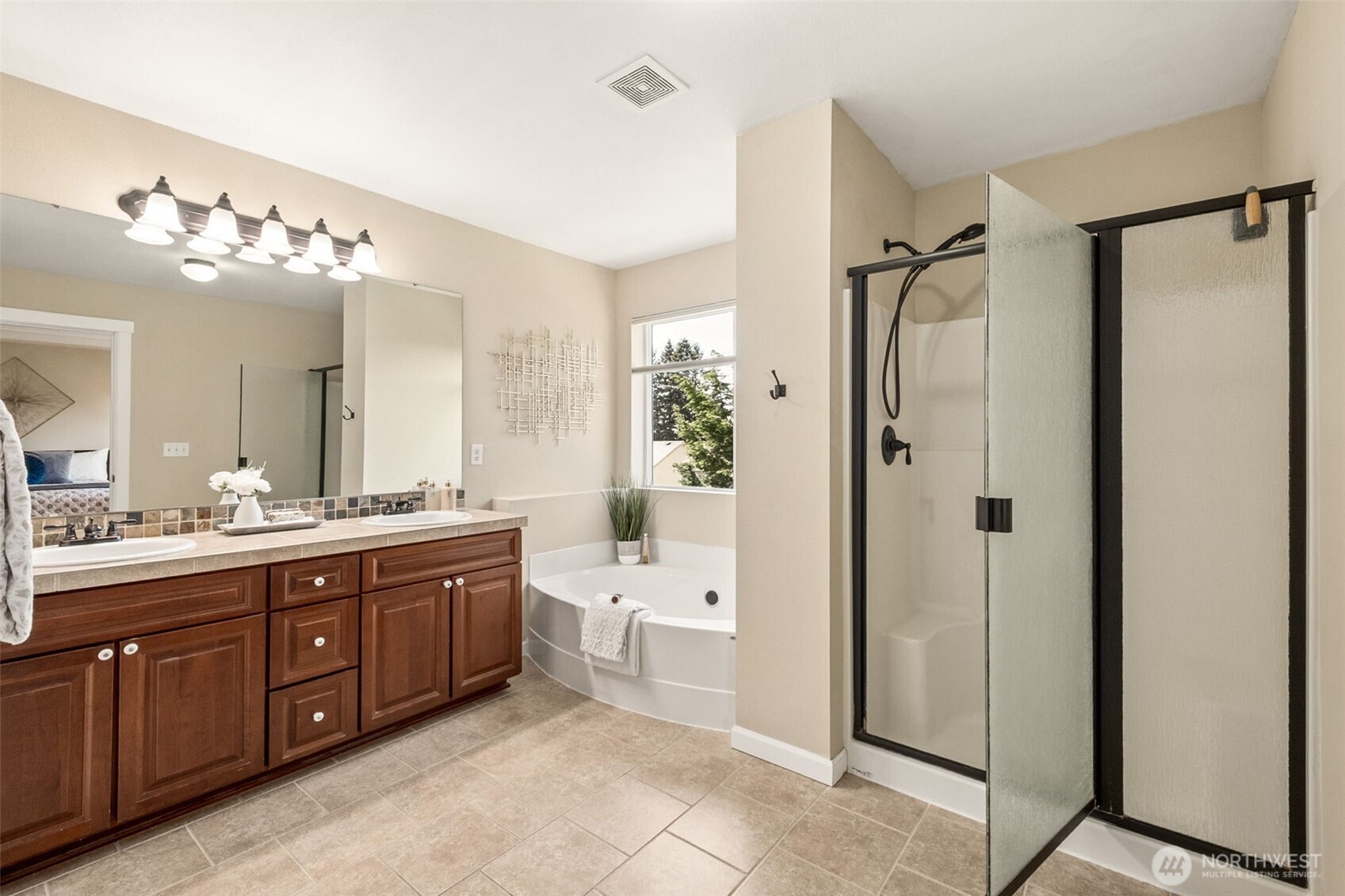 Generous 5-piece primary bath with dual sinks, relaxing soaking tub, separate shower, and great natural light.