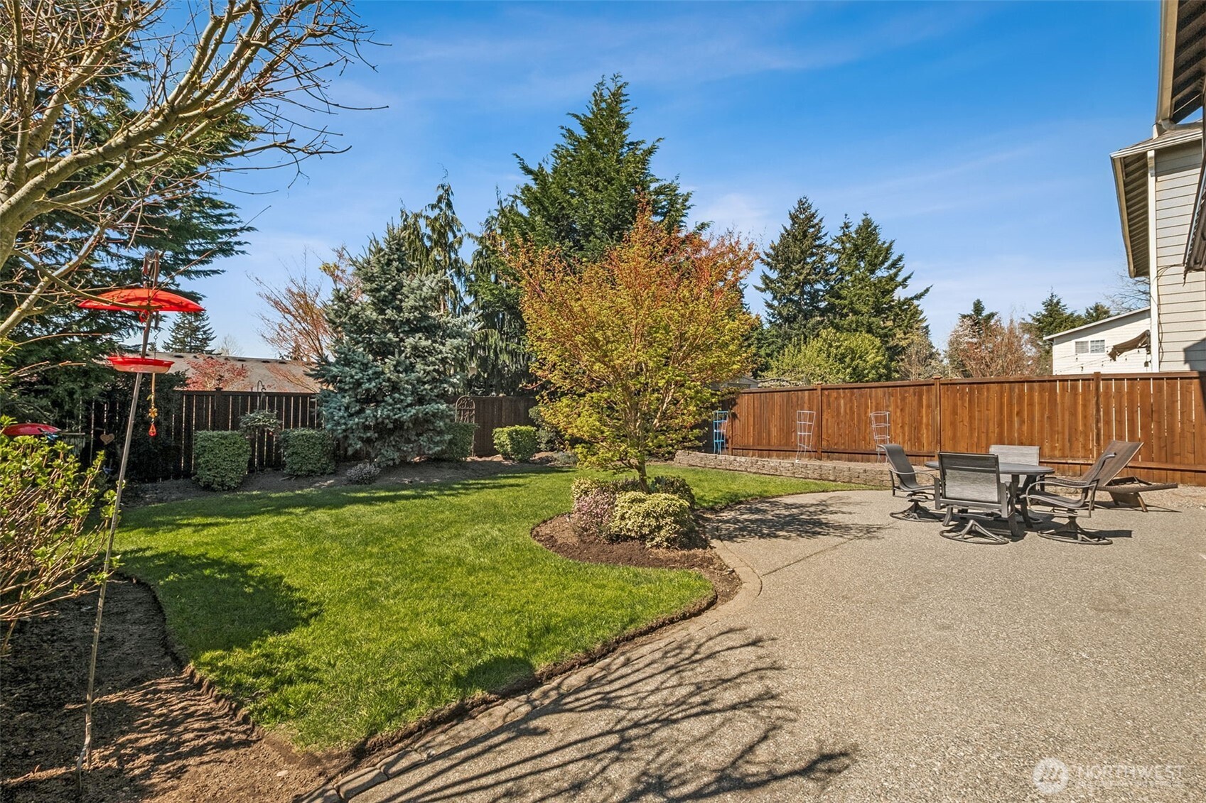 Private, beautifully landscaped backyard with lush lawn, mature trees, and a spacious patio—perfect for relaxing barbecuing & entertaining!