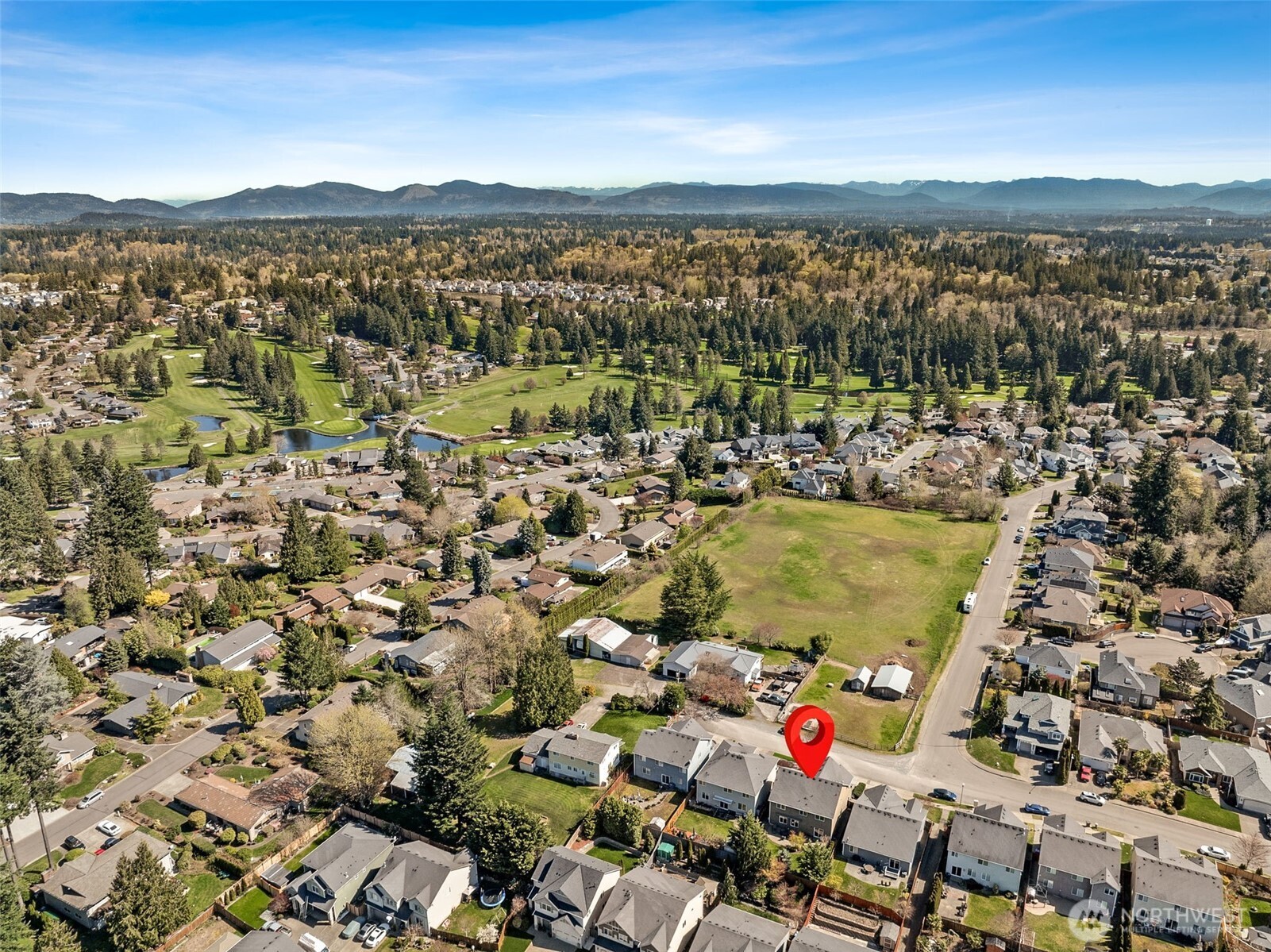 Enjoy peaceful front porch living with pastoral farm views across the street and the Cascade Mountains rising beyond.
