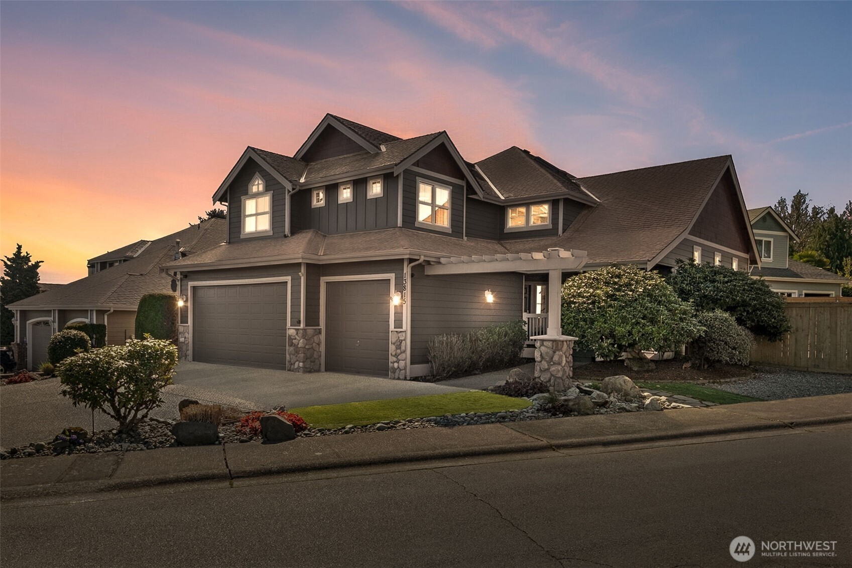 This incredible home starts with all the architectural detail from the outside! Stone-wrapped columns ... Vertical board-and-batten style paneling ... welcoming pergola ... dynamic multi-gabled roofline.