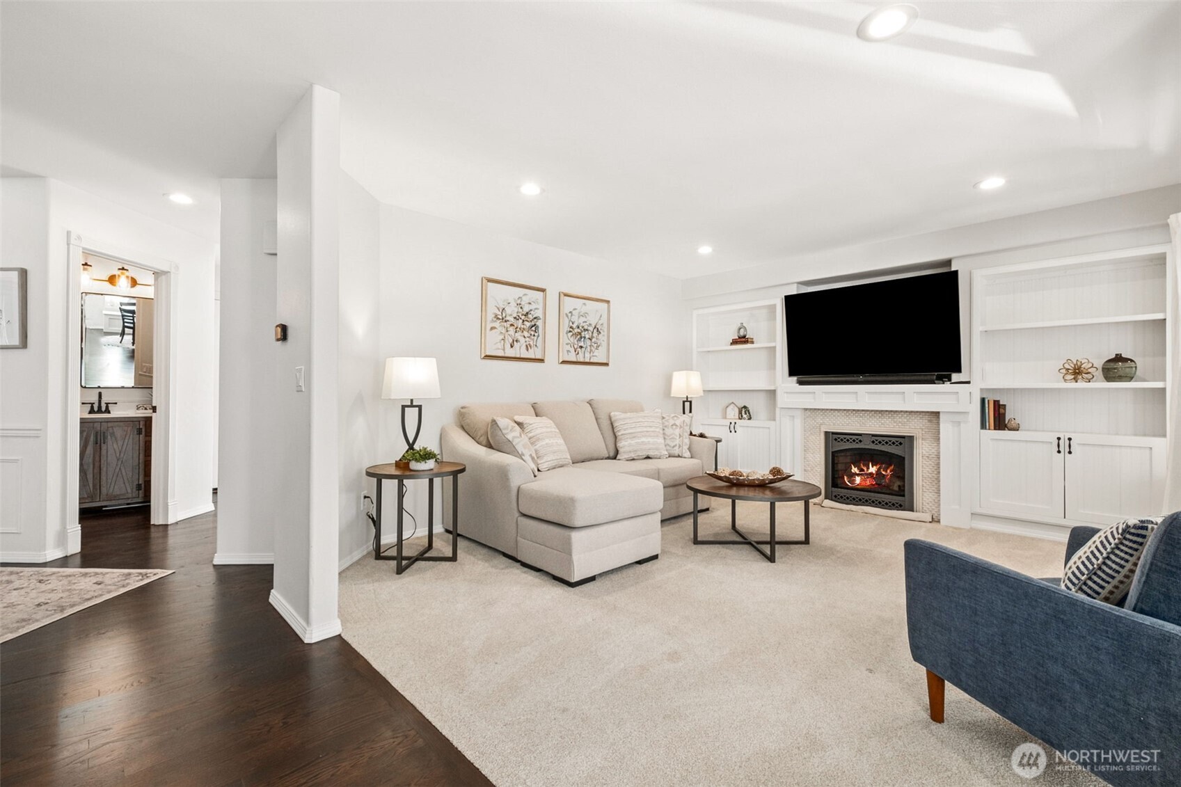The owners repainted the wood built-in shelves flanking the fireplace and added the doors at the bottom for functionality as well as form.