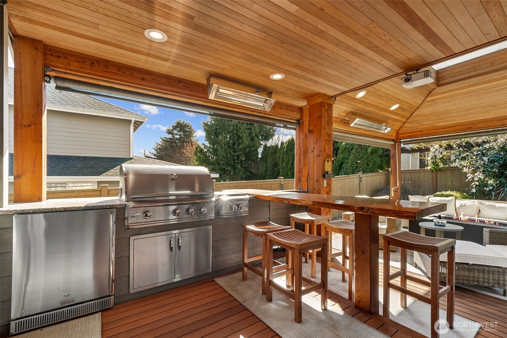 Here's a sneak peak of what's outside those French Doors! A well-appointed outdoor kitchen featuring a built-in grill, beverage refrigerator, live-edge raised bar seating for effortless entertaining! (More to follow)