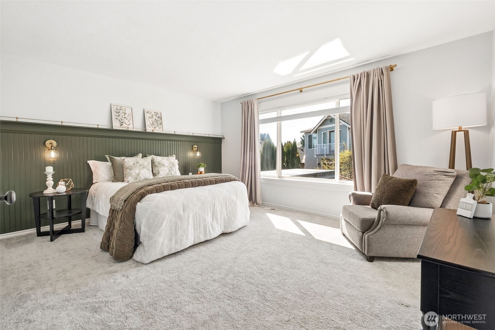 The expansive primary suite received an intentional artistic upgrade with the custom beadboard wall with display shelf.