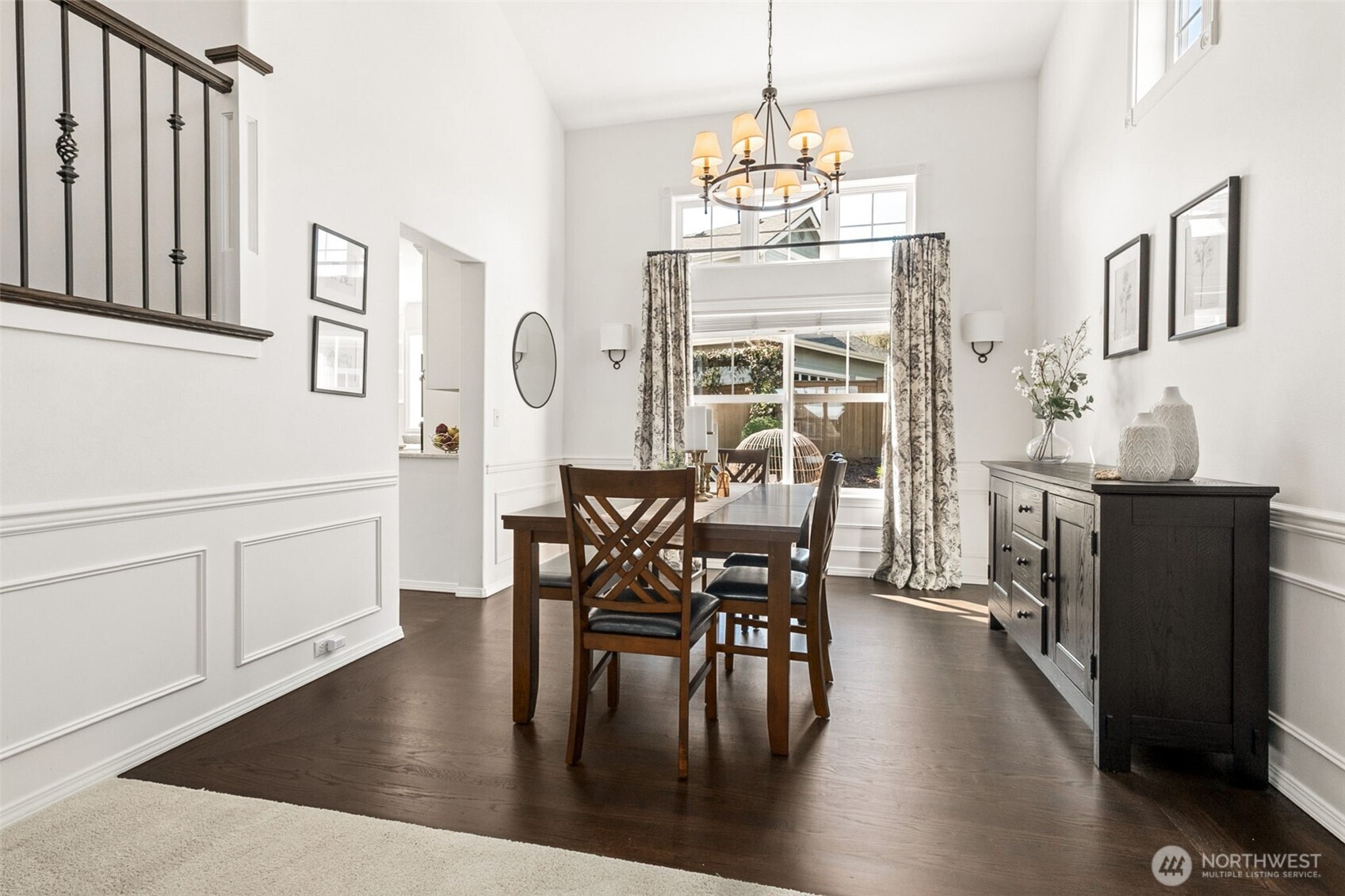 The shadow box detail, impressive lighting fixture, and plethora of windows make this dining room extra special.