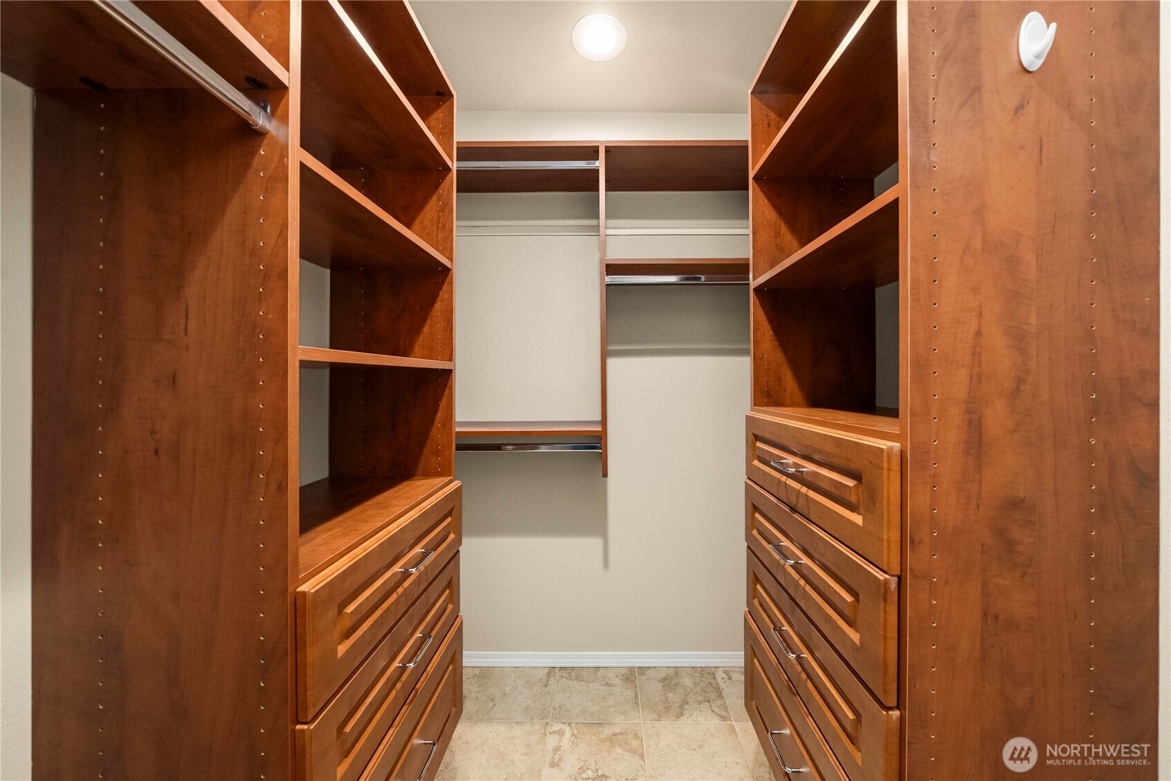 Primary walk-in closet with custom built-ins.
