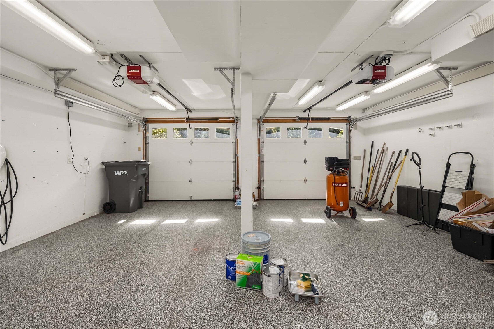 A two car garage that lives like a year-round dream workshop—heated and insulated with an epoxy floor and dual 220-amp circuits. EV-ready with an installed Tesla charger.