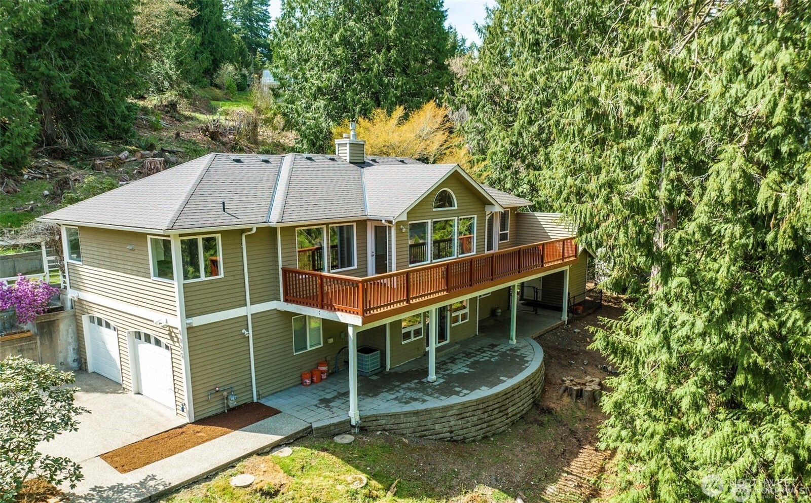 Ariel view of back exterior of the home. Versatile outdoor spaces.