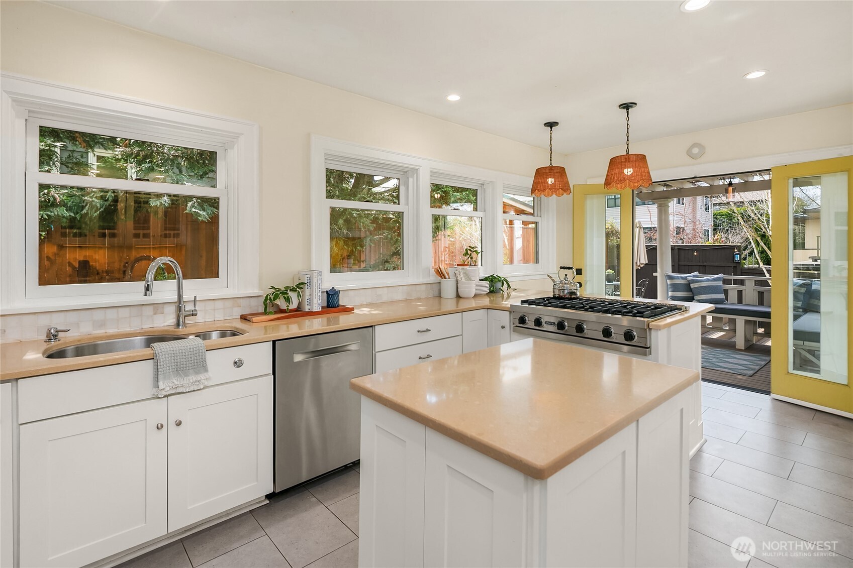 Kitchen opens to back deck and yard through French doors.