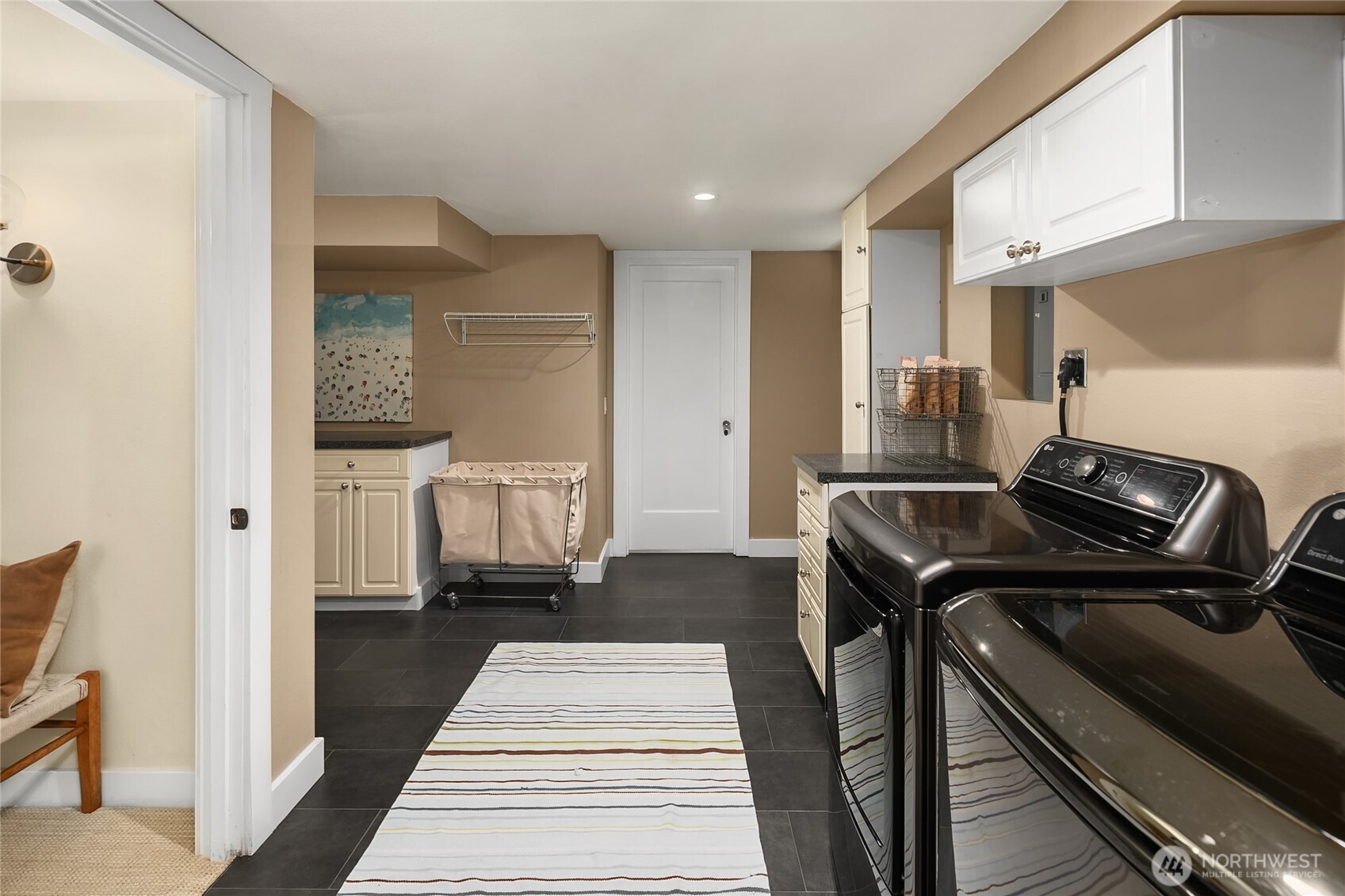 Updated laundry room with adjacent large storage room.