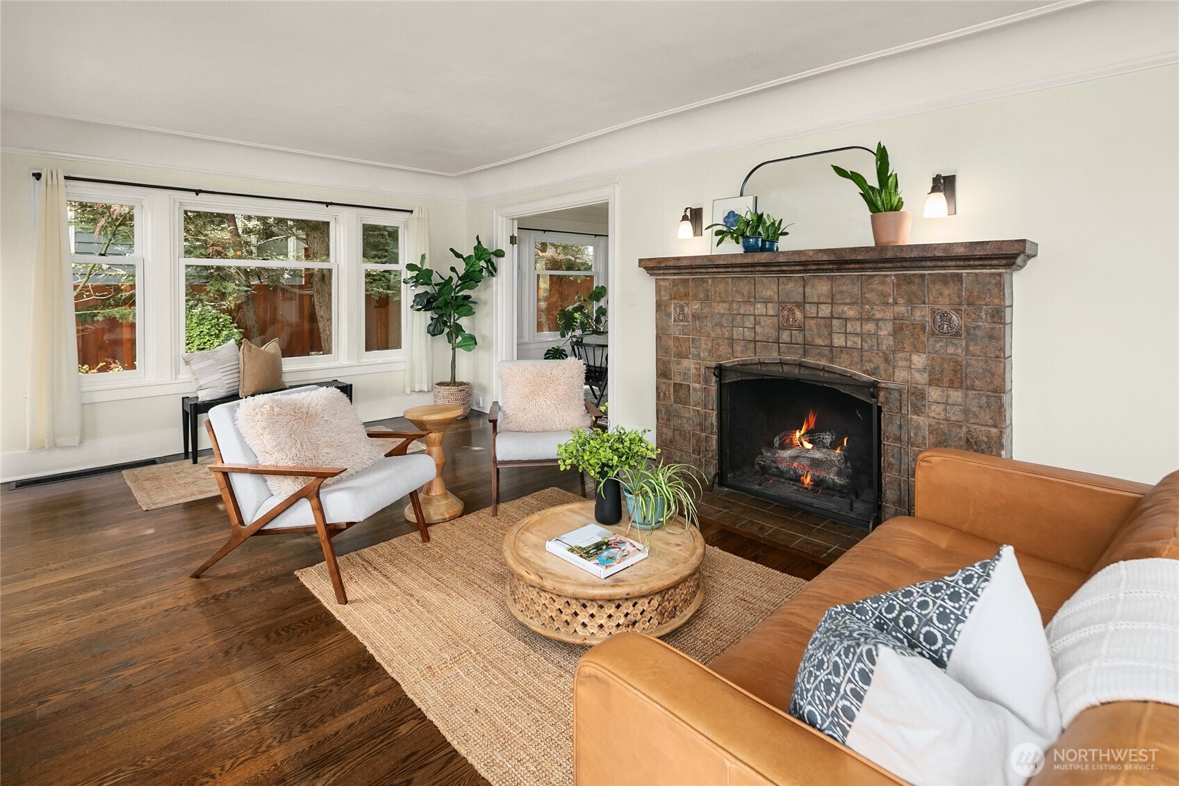 Cozy period fireplace plus a wall of built-in bookcases and window seat to relax and reflect.