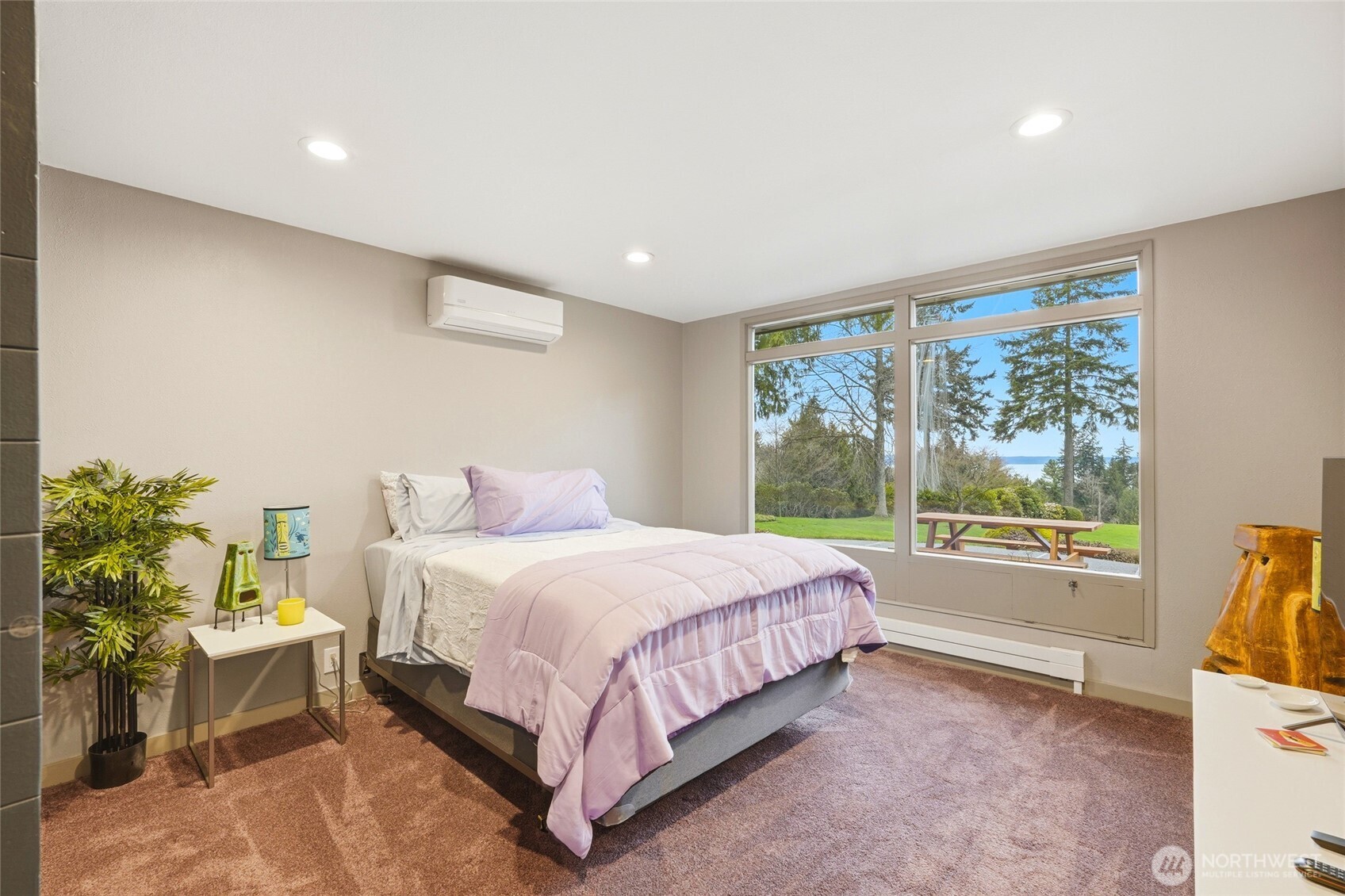 This bedroom is located behind the family room and features a view and access to an adjacent bedroom.