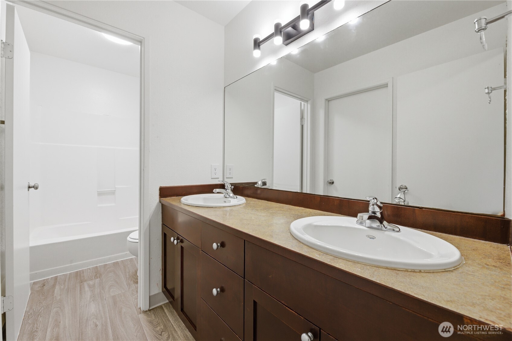 Another view of the primary boasts large mirrored door closets.