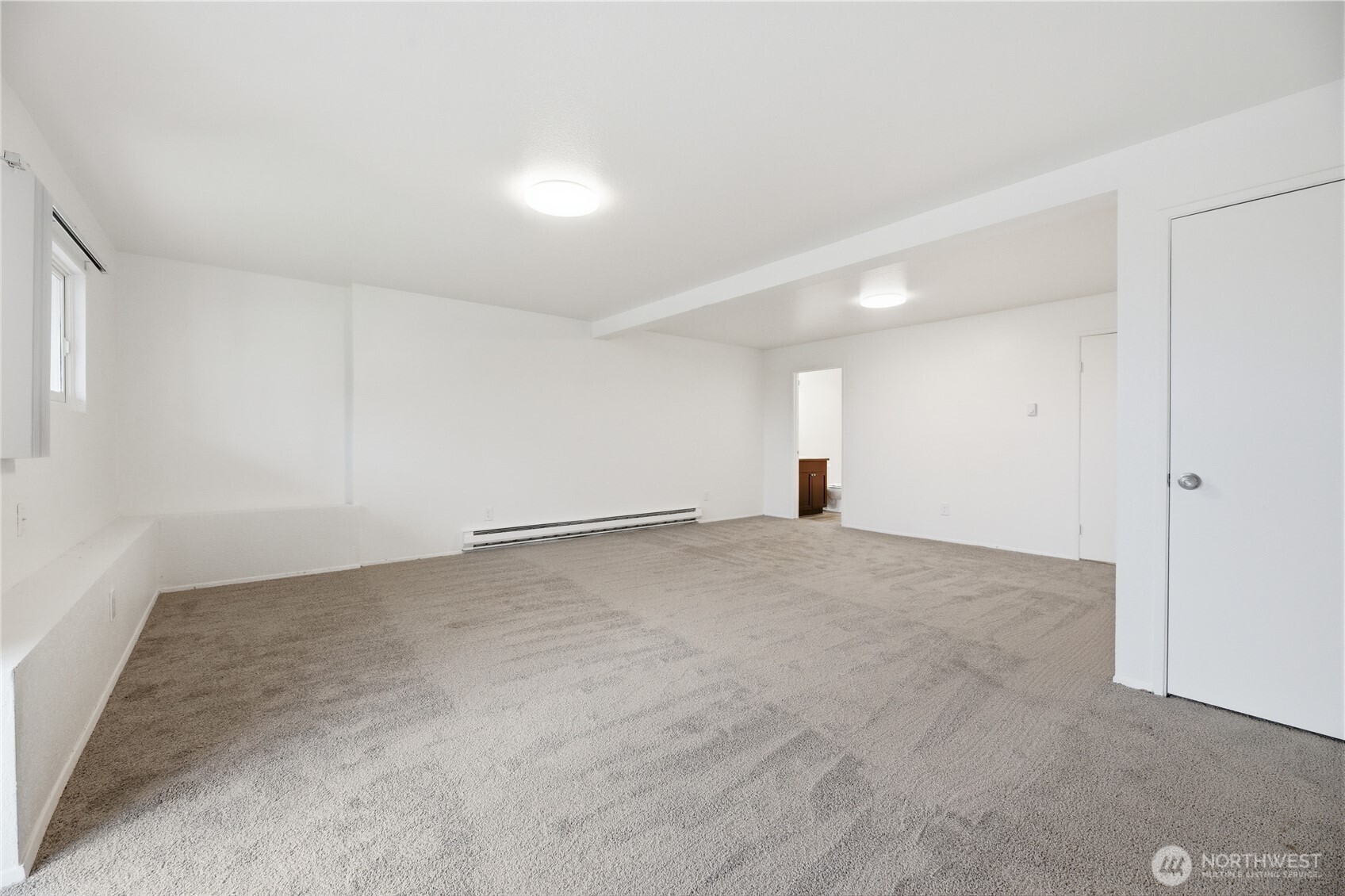 Another view of the upstairs guest bedroom with mirrored closet doors.