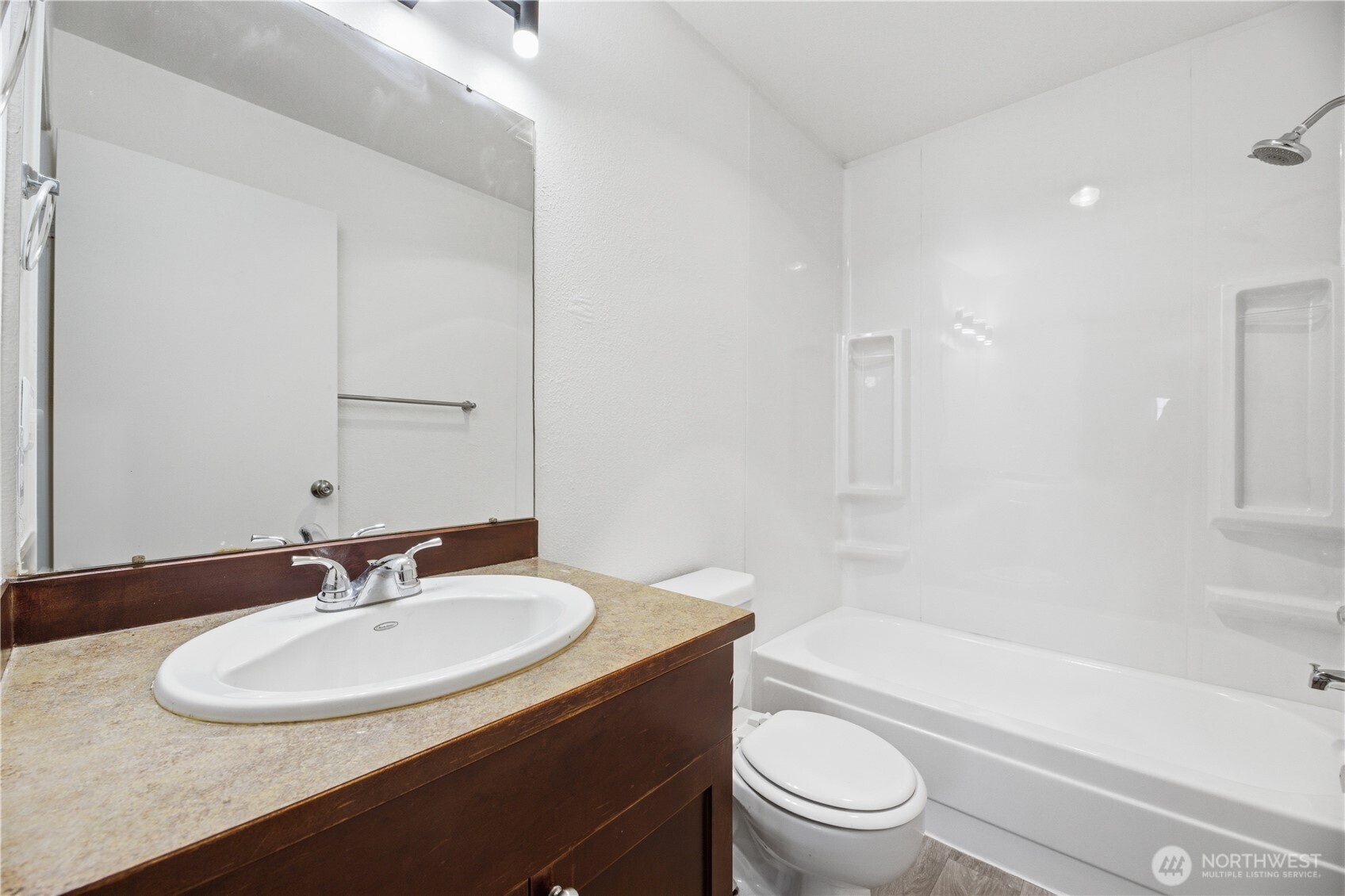 Large downstairs bedroom offers versatility with direct access to the backyard space.