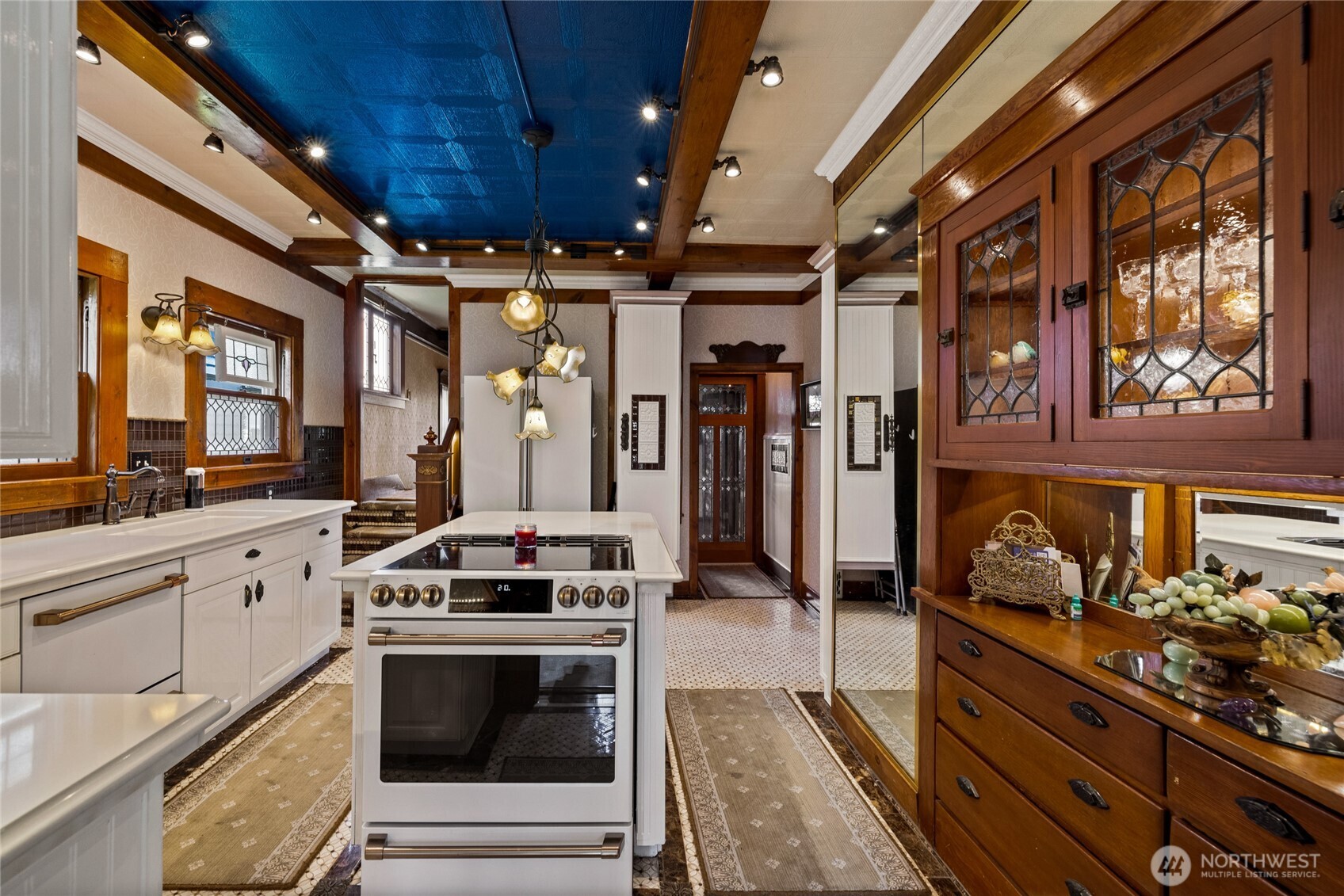 Updated kitchen blends luxury & heritage with high-end appliances, quartz counters & built-in featuring a charming pass-through to dining room.  GE Cafe appliances.