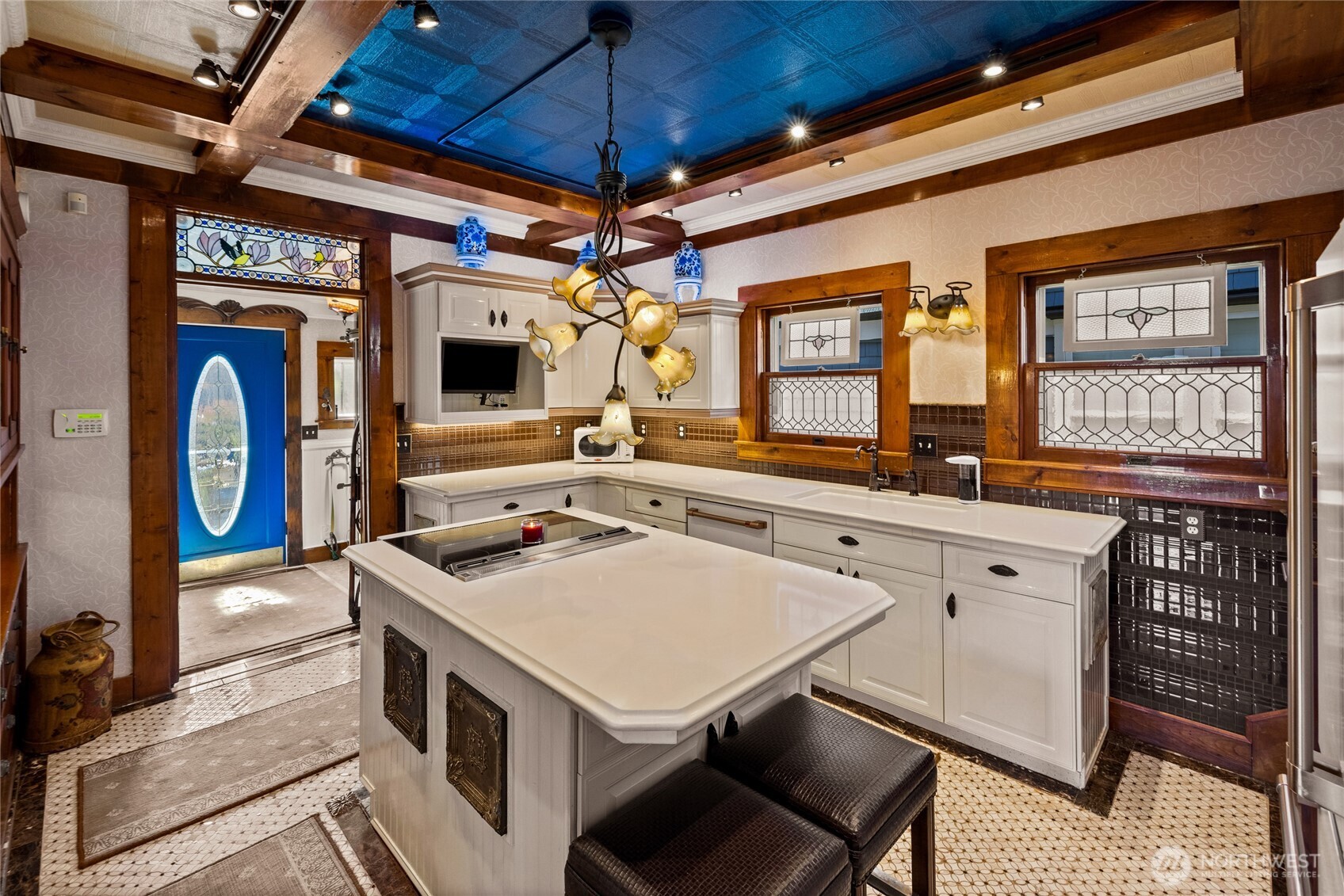 Blue door with oval glass leads to the deck & ornamental garden