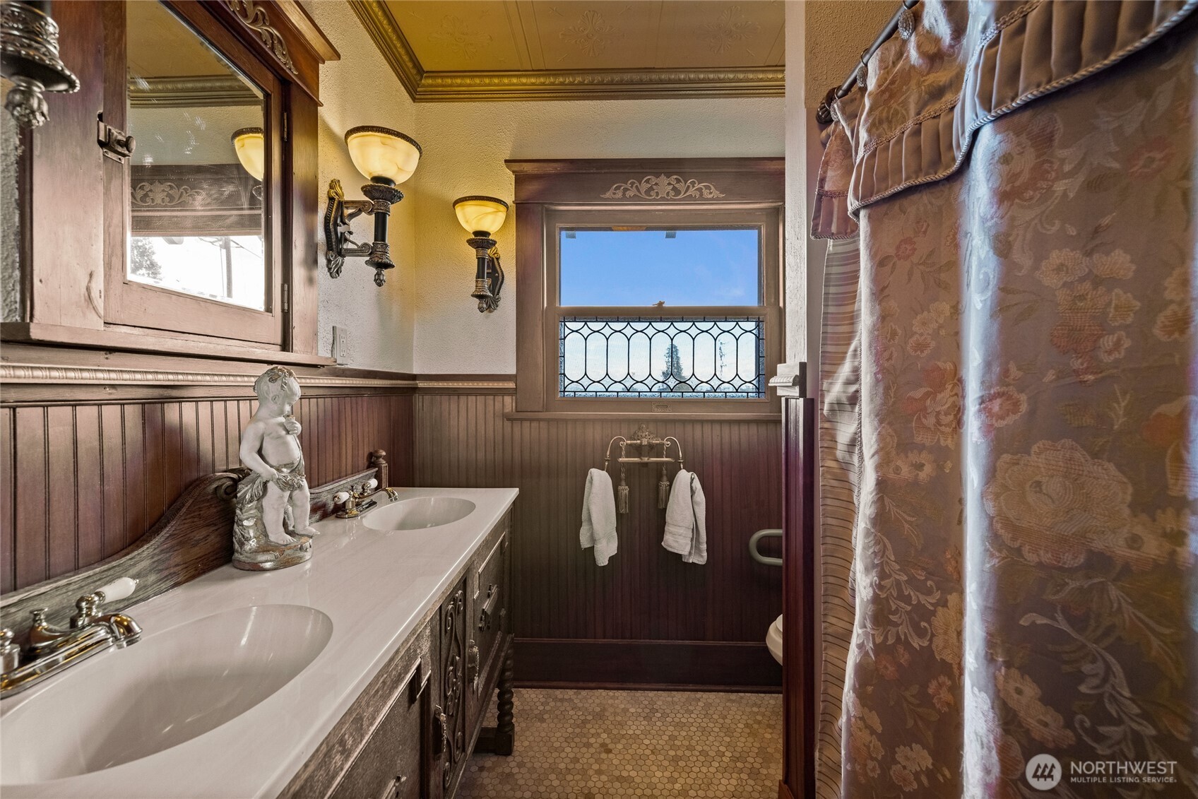 Second floor bathroom with repurposed antique furniture for the vanity.