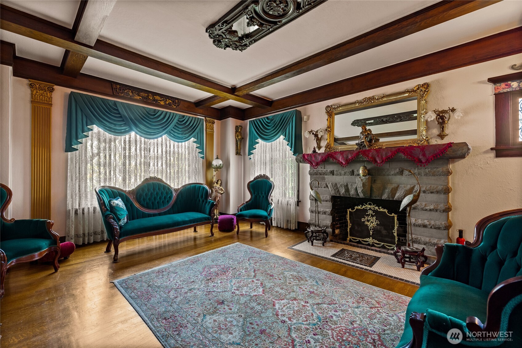 Large windows offer great natural light.  Classic swag & jabot drapes.