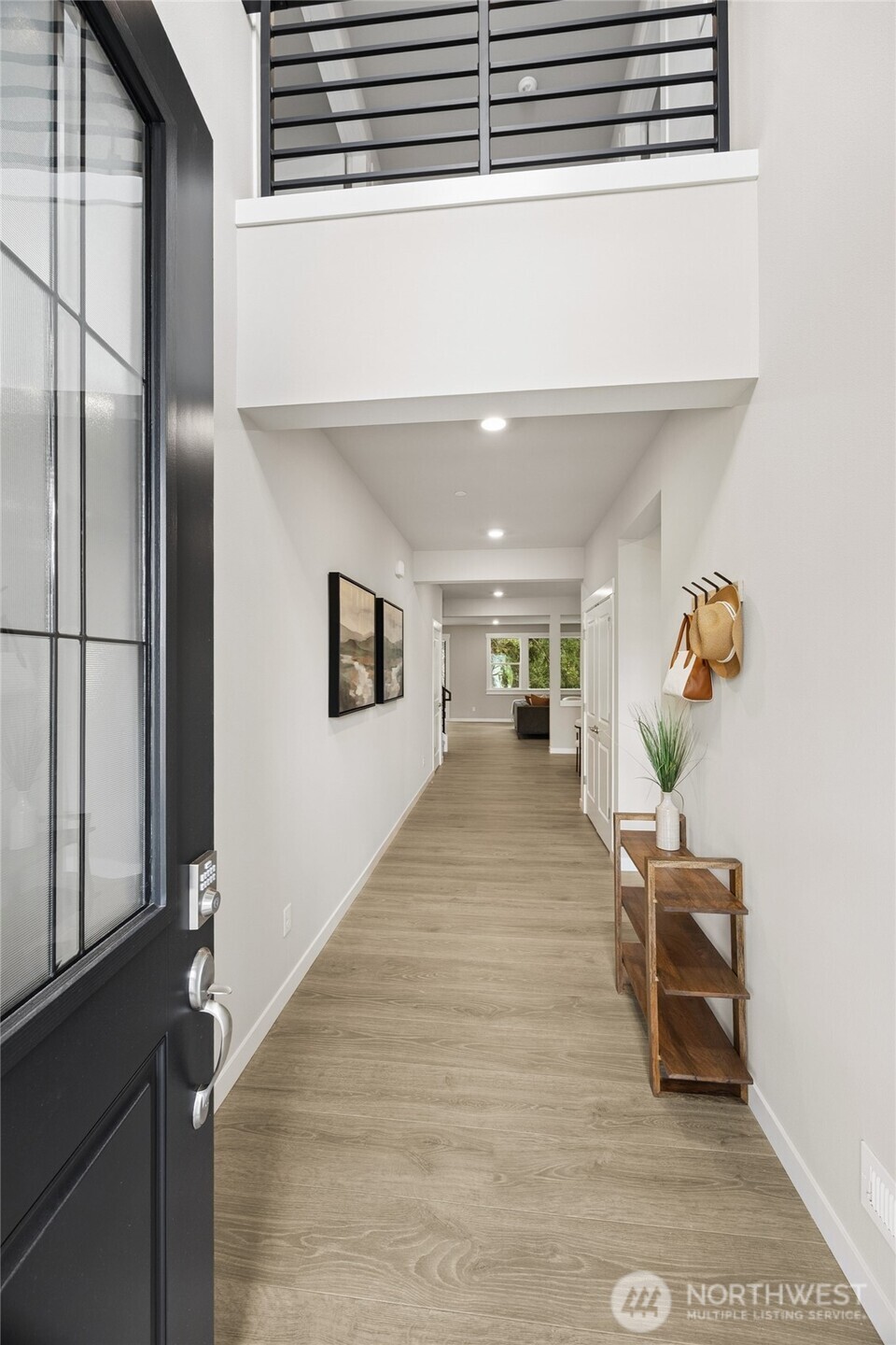 Light-filled entry way with modern flooring, recessed lighting and clean contemporary design.