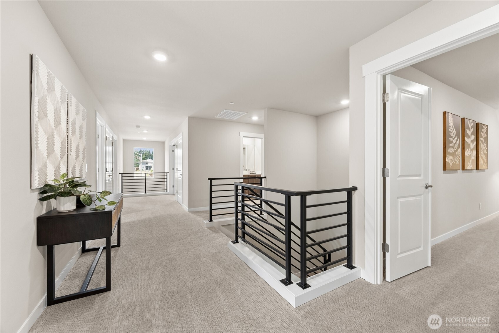 Open loft-style hallway with sleek railing detail for flexible use.