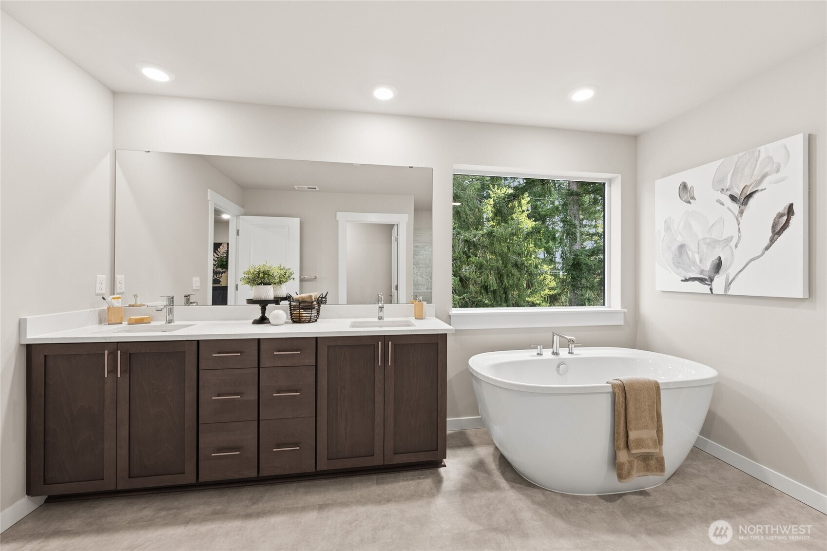 Primary bath with soaking tub, dual sinks, and a bright, serene setting.