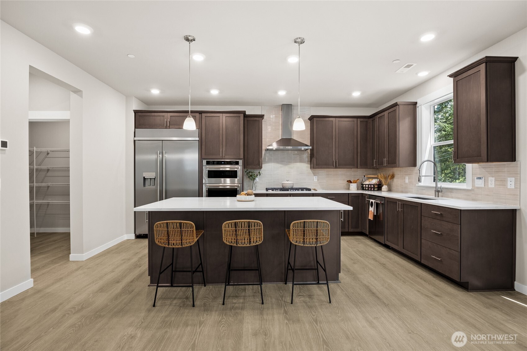 Chef-inspired kitchen with large island, stainless appliances, and generous storage.