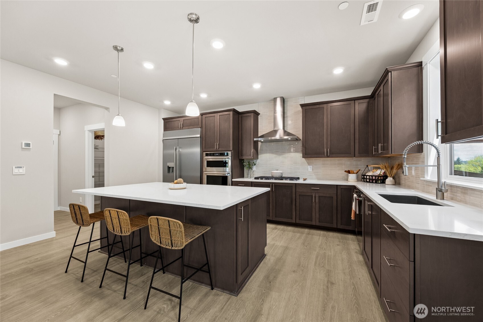 Well-designed kitchen with expansive island, generous storage, and sleep finishes.