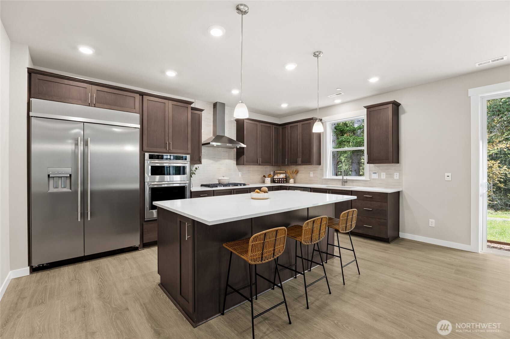 Kitchen featuring gas cooktop, built-in microwave and oven, and access to the outdoor space.