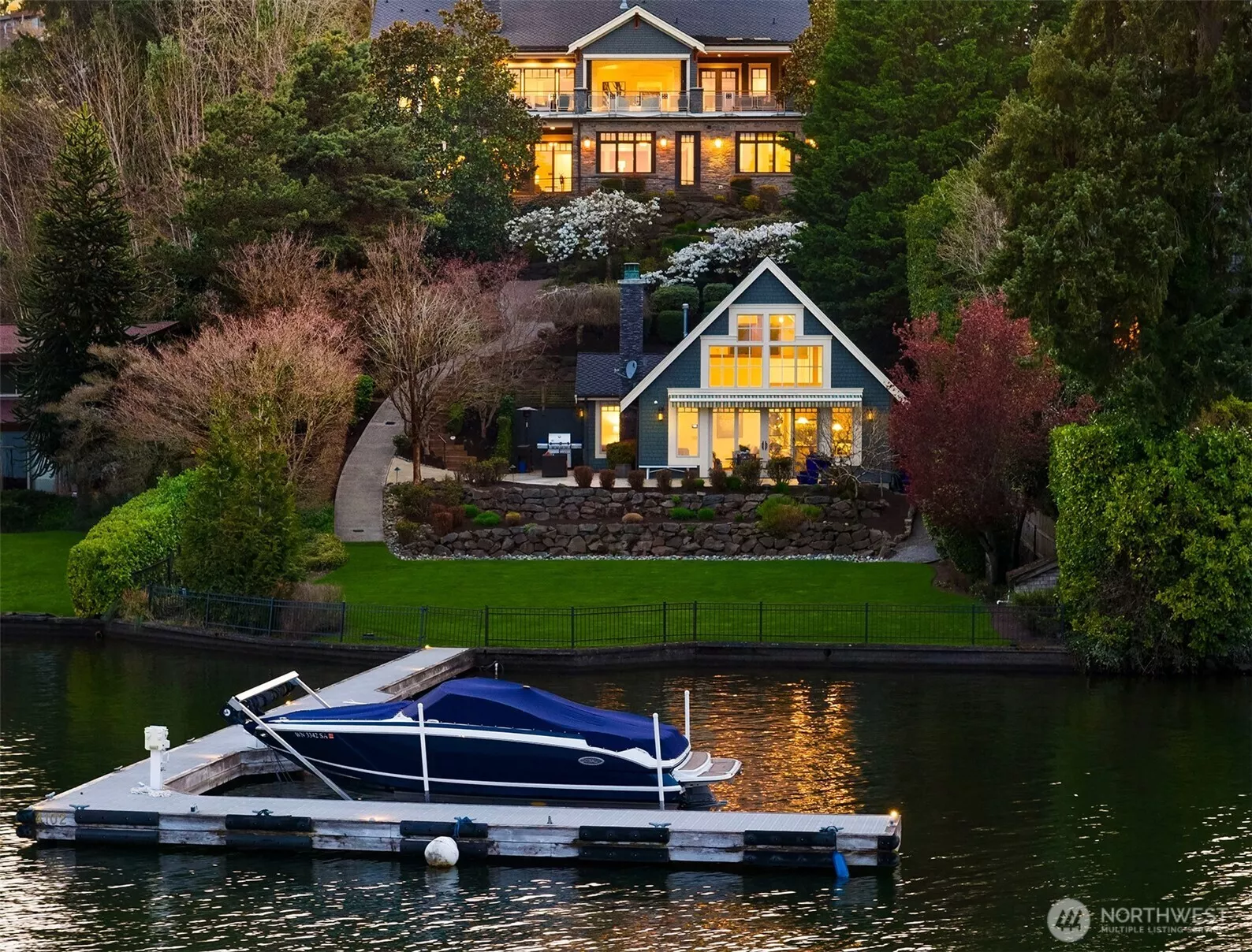 Positioned proudly on the north end of Mercer Island, discover a Modern Craftsman with an charming beachside guest house right at the water's edge.