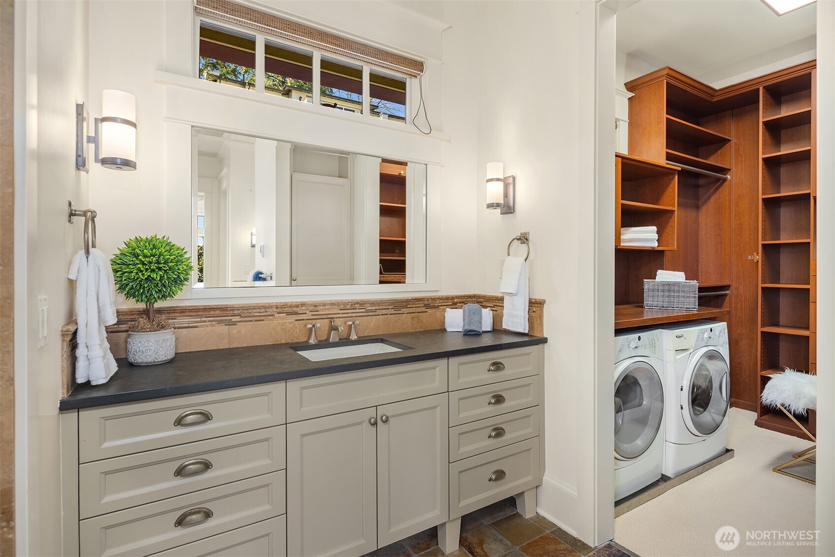 Even the laundry is effortless in the primary suite, with a discrete washer and dryer adding to the spa-level ease.