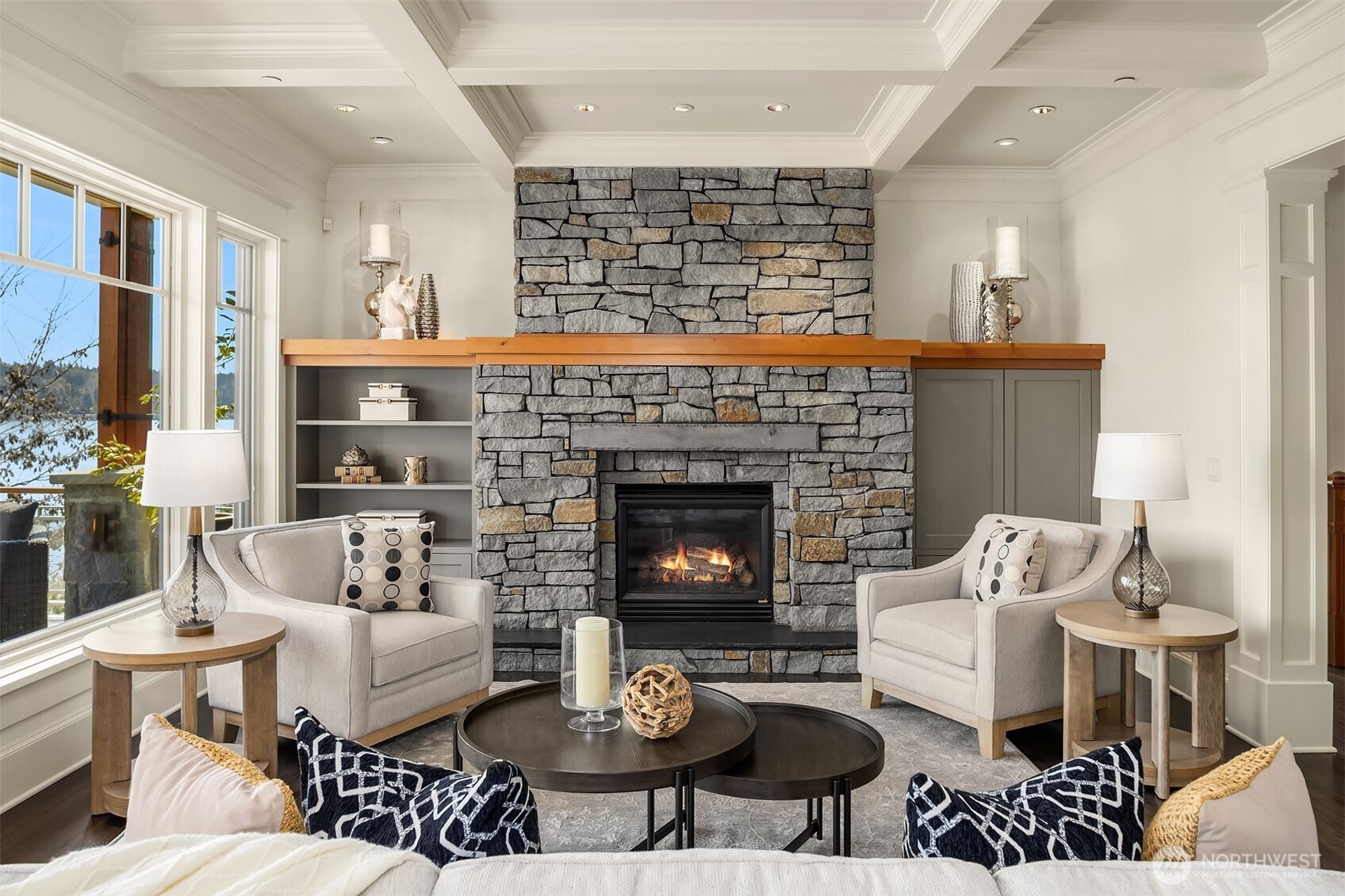 A statement making stacked stone fireplace serves as an anchor in the Great Room offering the space weight, warmth and undeniable presence.