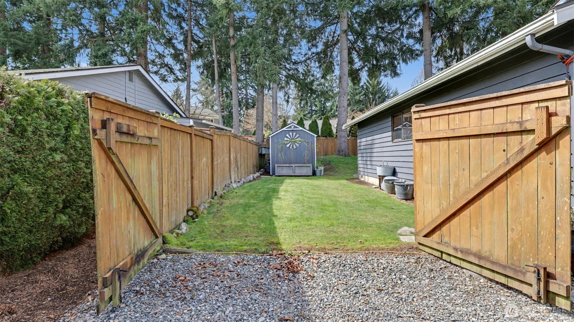Huge side yard. Very easy conversion to RV, Trailer or boat parking behind the large gates. This side yard is over 40' long. Located on the left side of the garage.