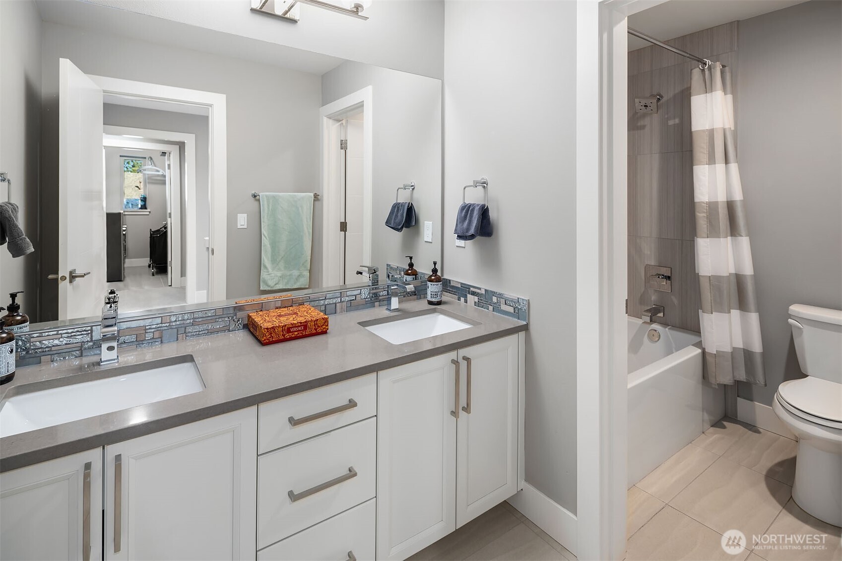 Hallway full bathroom with double vanities