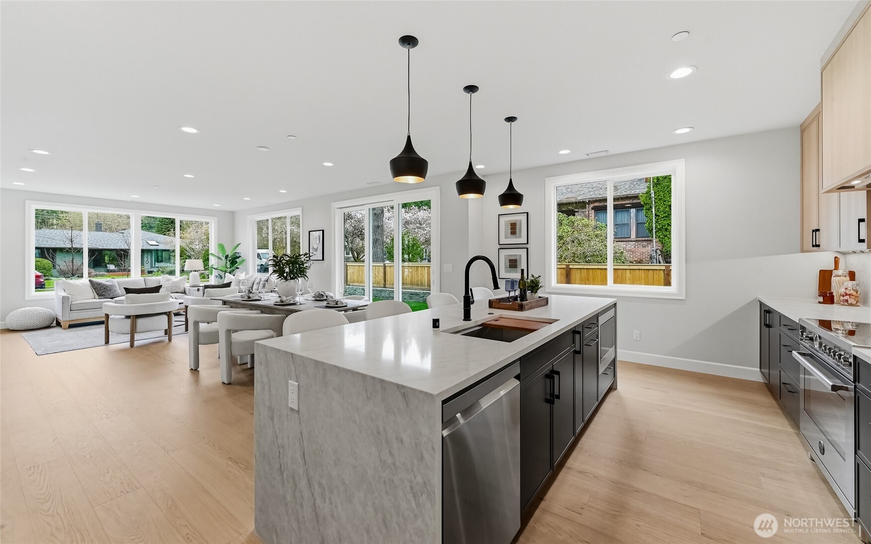 The dining room takes in glimpses of the generous kitchen area