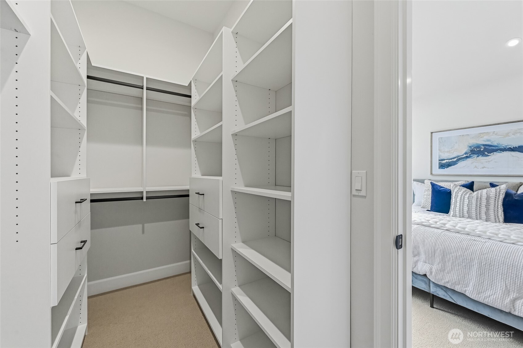 Primary closet with upscale built ins to make your closet life more organized.