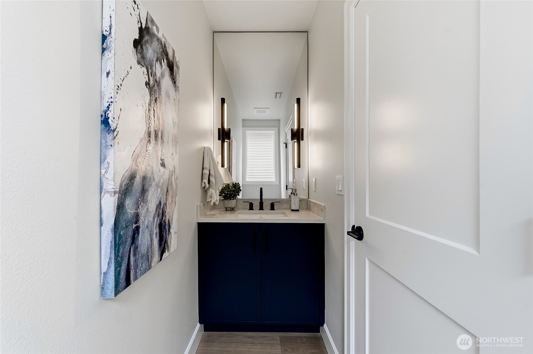 Downstairs powder room discreetly tucked out of site