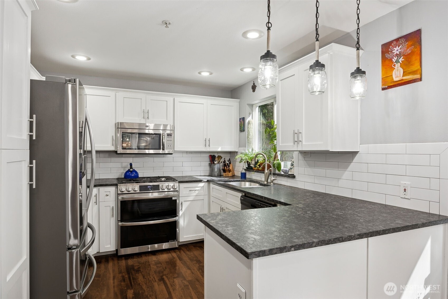 Designed for both everyday living and entertaining, the kitchen opens naturally to the nook and adjacent living room.