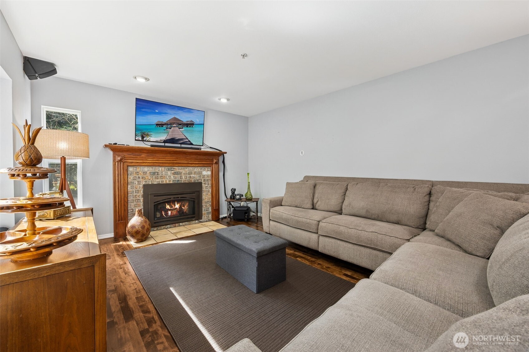 The living room offers a spacious, comfortable retreat with seamless flow to the kitchen and nook.