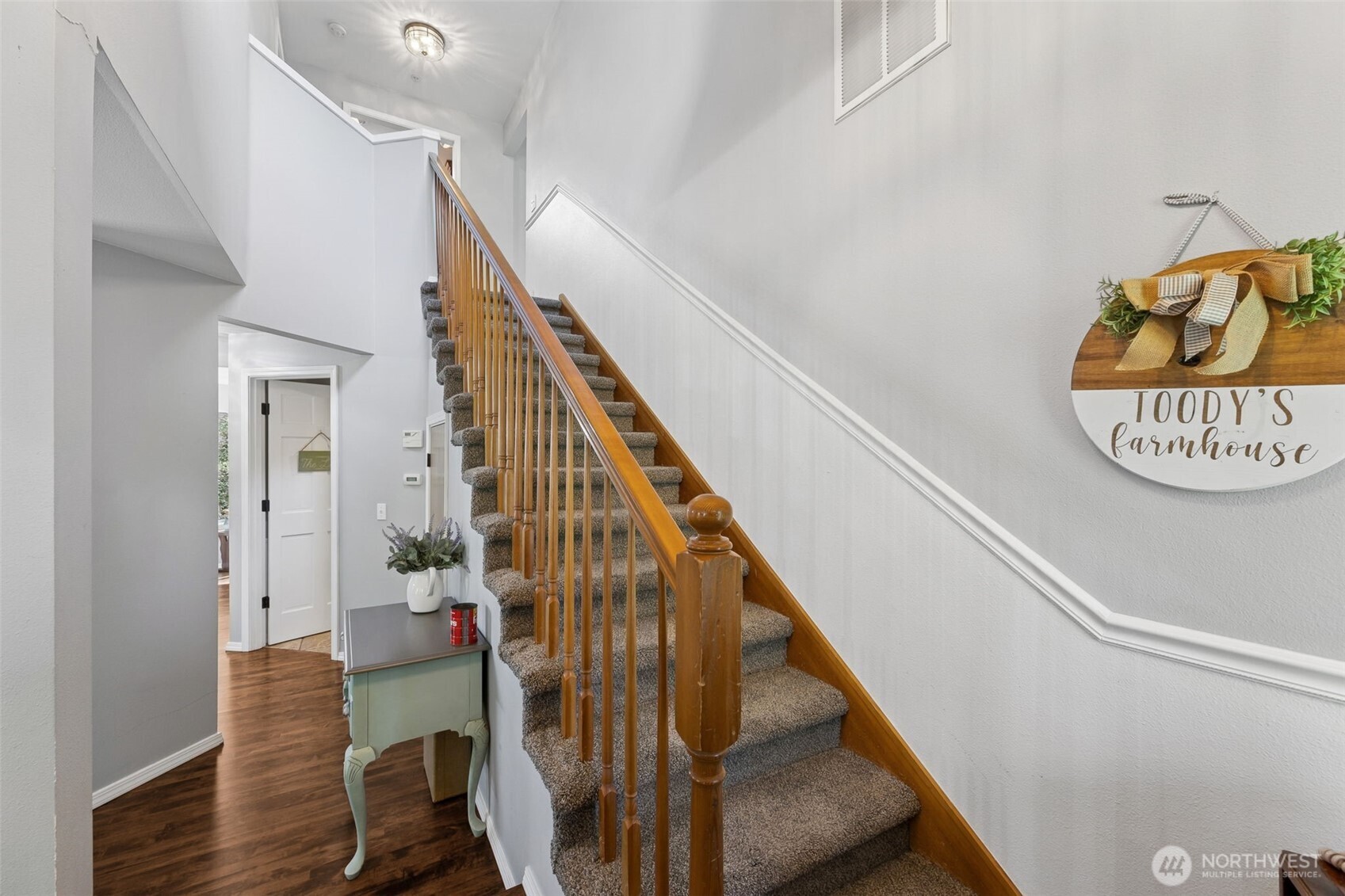 Step inside to a warm and inviting entryway highlighted by elegant stairs and abundant natural light.