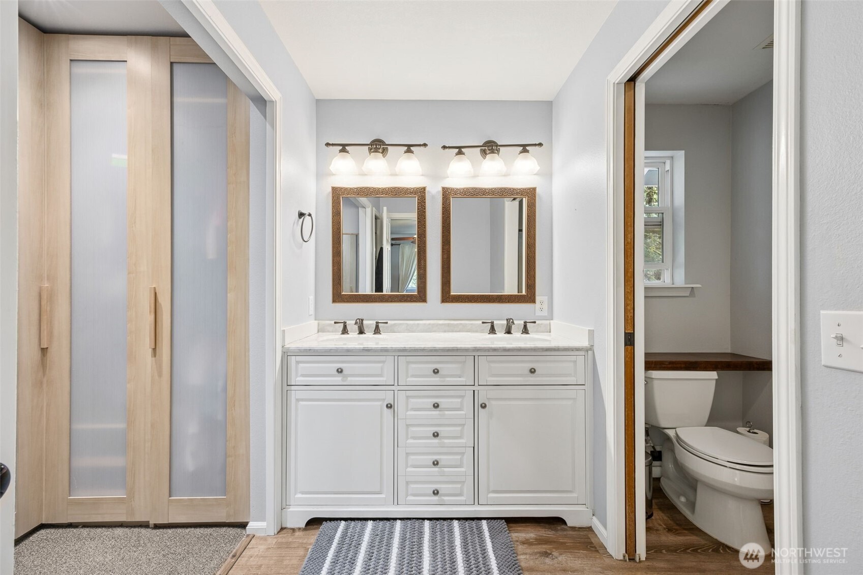 A luxurious en-suite bathroom featuring a dual sink vanity, perfect for convenience and style.