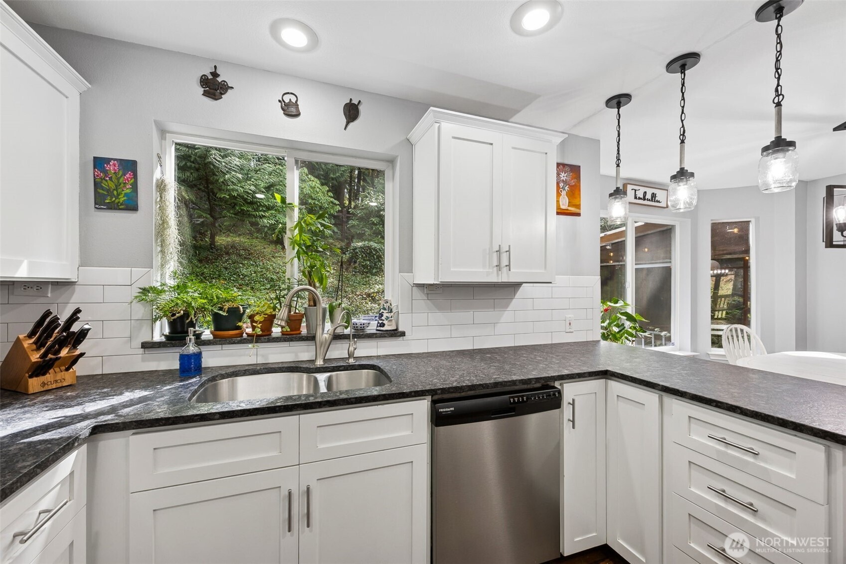The spacious kitchen sits at the heart of the home, flowing seamlessly into the cozy nook and inviting living room.