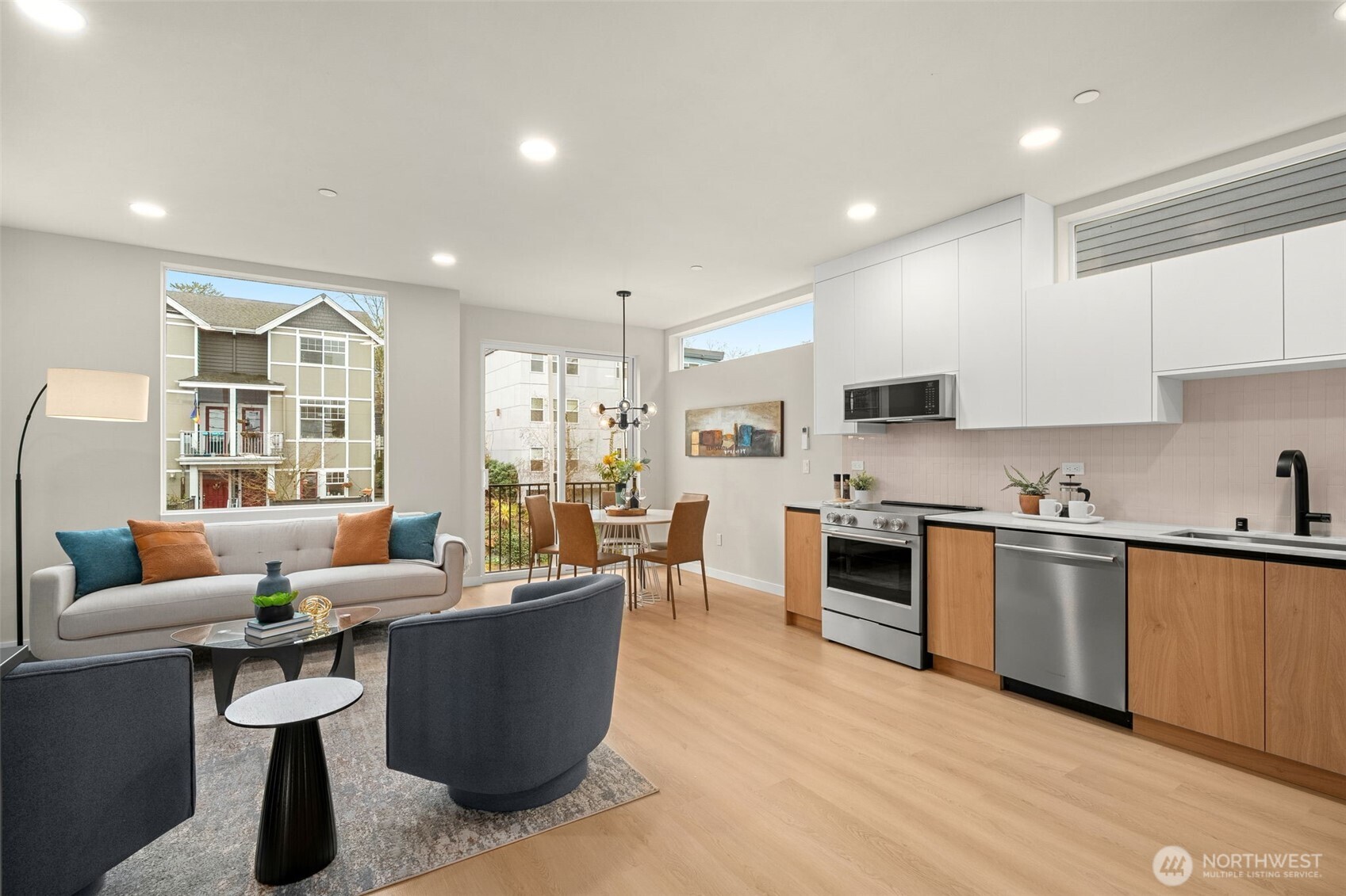 The heart of the home: a sophisticated great room where the gourmet kitchen flows effortlessly into the living and dining areas