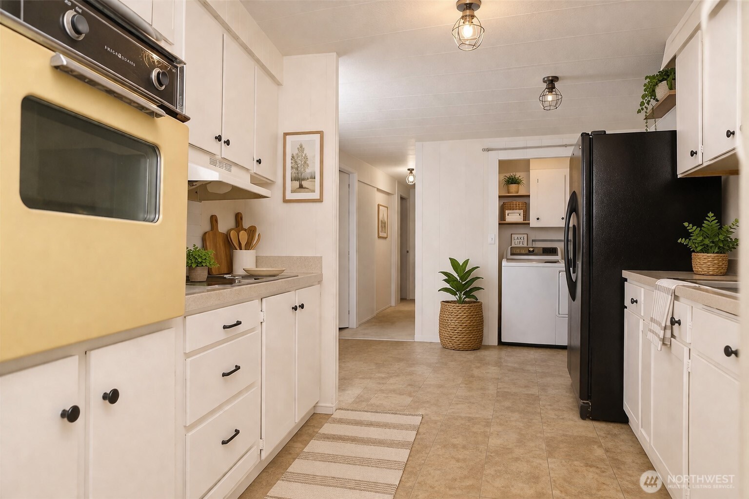 The kitchen features an electric stove, built-in oven, and ample cabinetry for generous storage and functionality.  VIRTUALLY STAGED