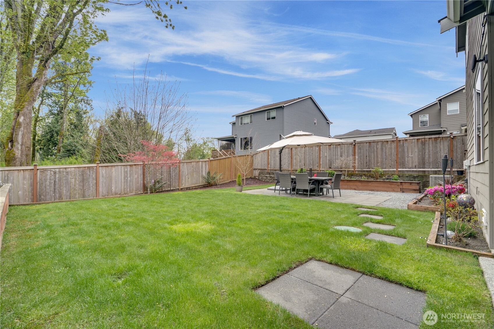 Fully fenced and backs up to green space with mature trees. Both the front and backyard have full sprinkler systems, including the garden beds.