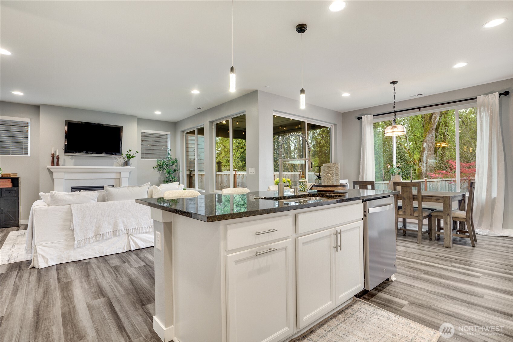 Walls of windows, 9’ ceilings and natural surround keep this home feeling well lit throughout the year.