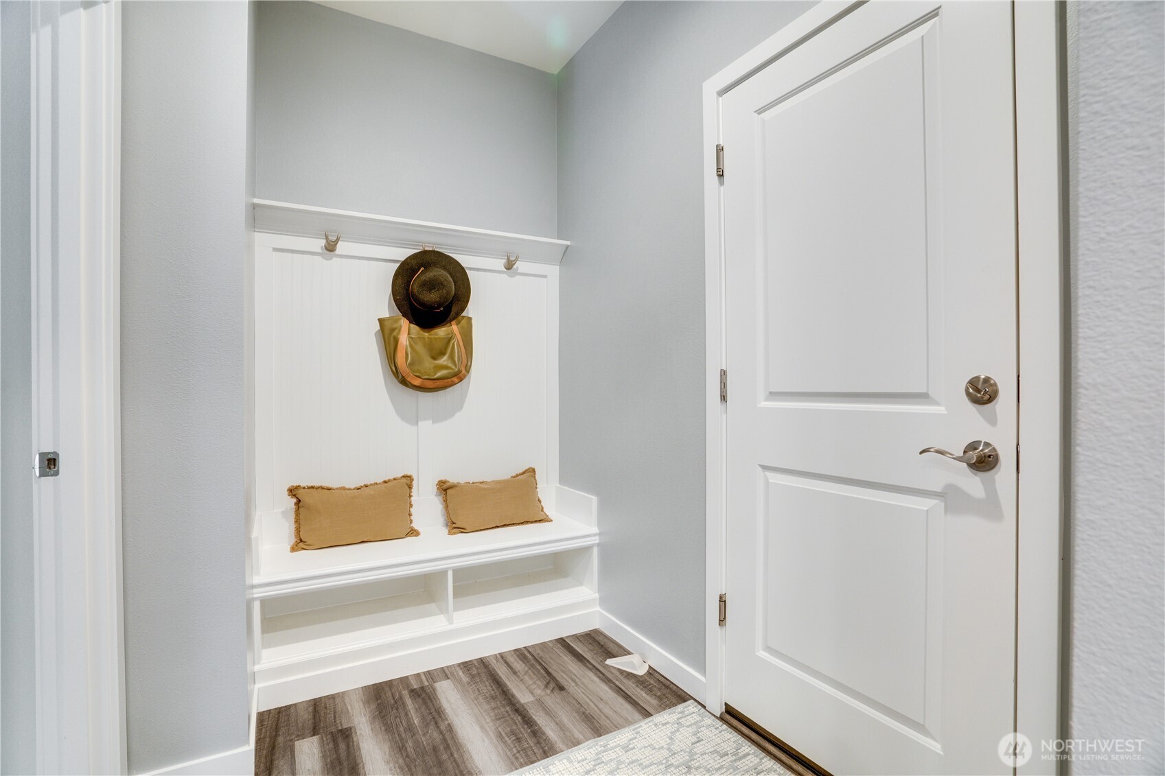 Door on the right leads to the 2-car garage. Inside garage is a level2 car charger. On the left is the Junior Suite on the main floor!