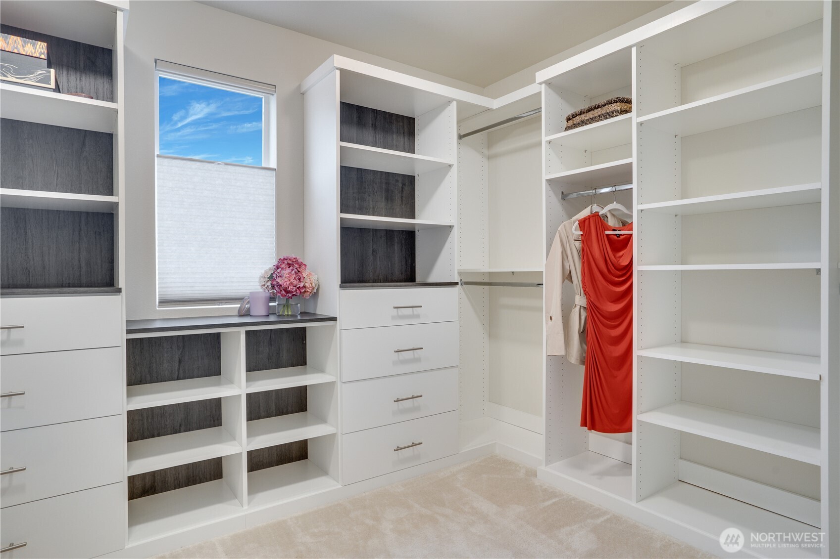 Luxurious custom closet design in the primary bedroom, complete with hanging space, soft close drawers and shelving. All bedrooms have walk-in closets.