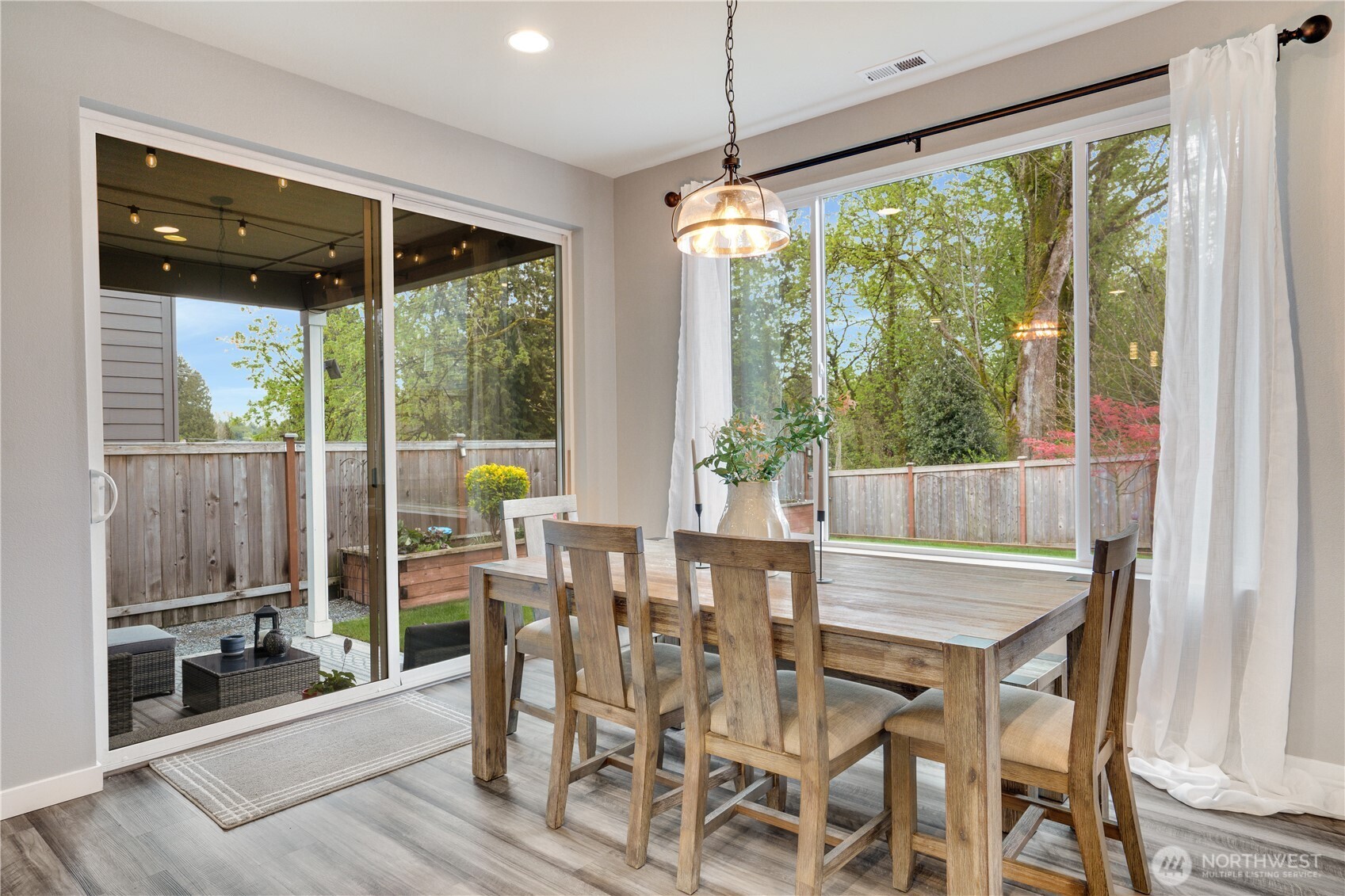 Formal dining overlooks the covered patio and private fully fenced yard.