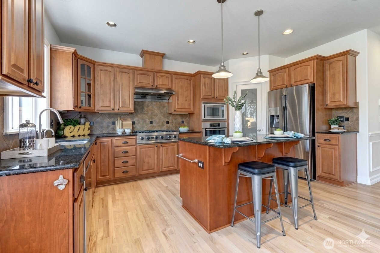 Gourmet Kitchen w/ custom cabinetry, granite countertops, SS Appliances.